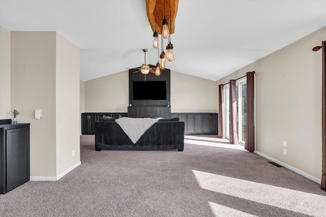 unfurnished living room featuring lofted ceiling, ceiling fan, carpet flooring, and baseboards