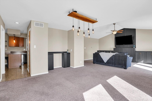 unfurnished living room with ceiling fan, lofted ceiling, visible vents, baseboards, and carpet