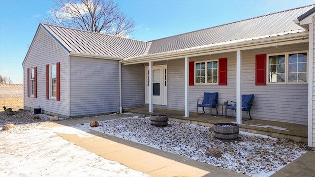 view of front facade with metal roof and a porch