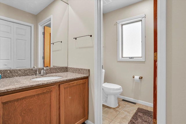 bathroom featuring visible vents, toilet, tile patterned floors, vanity, and a closet