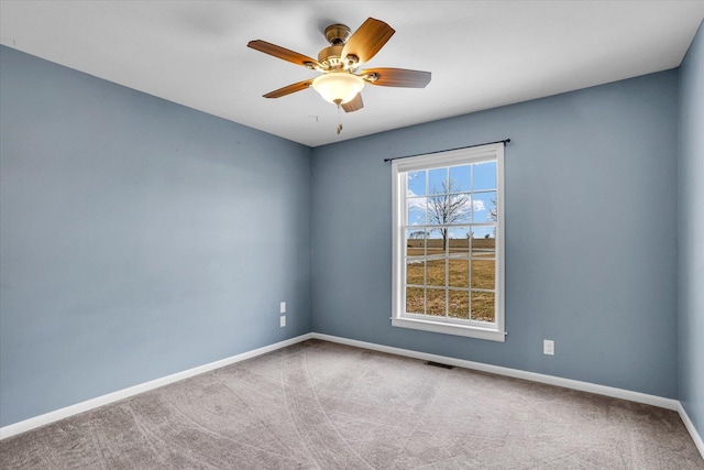 unfurnished room featuring a ceiling fan, carpet flooring, visible vents, and baseboards