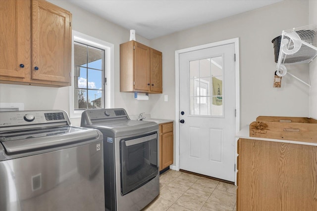 laundry room with an AC wall unit, cabinet space, washer and clothes dryer, and light tile patterned floors