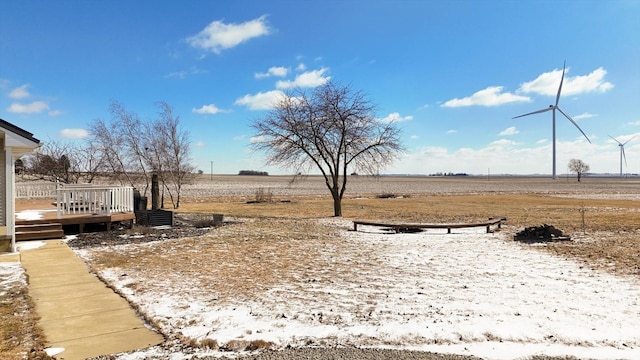 view of yard featuring a wooden deck and a rural view