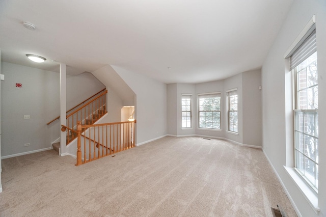 unfurnished room with light colored carpet