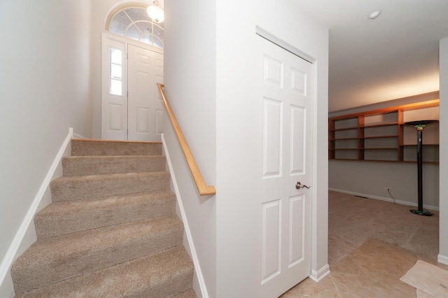 staircase featuring carpet floors