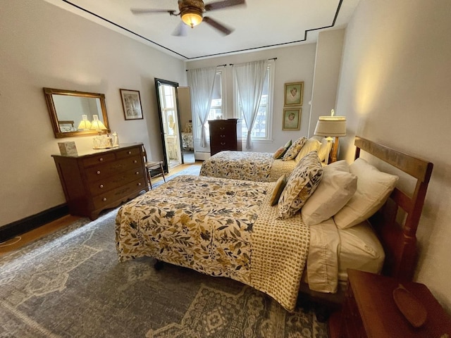 bedroom featuring baseboards and a ceiling fan