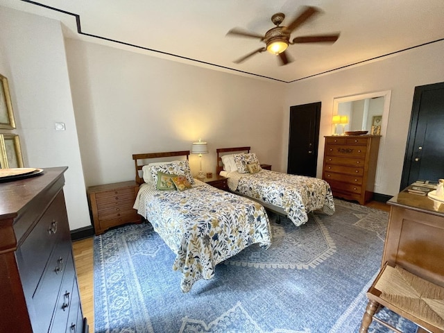 bedroom featuring a ceiling fan and wood finished floors