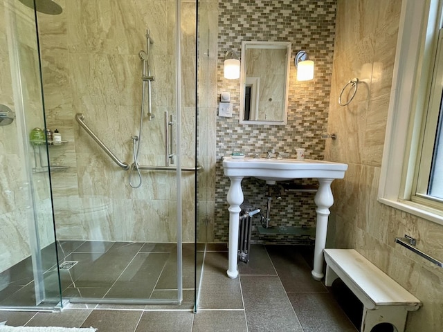 full bath with a stall shower and tile walls