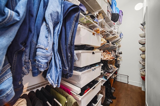 walk in closet with wood finished floors