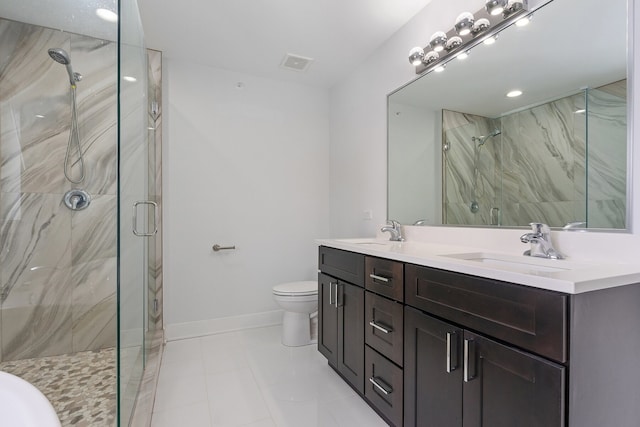 bathroom with vanity, toilet, tile patterned flooring, and a shower with door