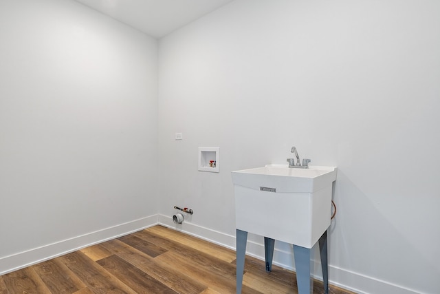 washroom featuring hookup for a gas dryer, hookup for a washing machine, wood-type flooring, and sink