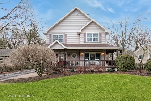 view of front of property featuring covered porch, a front lawn, and roof with shingles