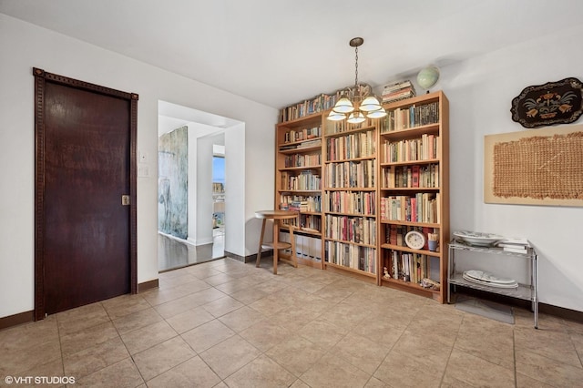 unfurnished room featuring light tile patterned floors and an inviting chandelier