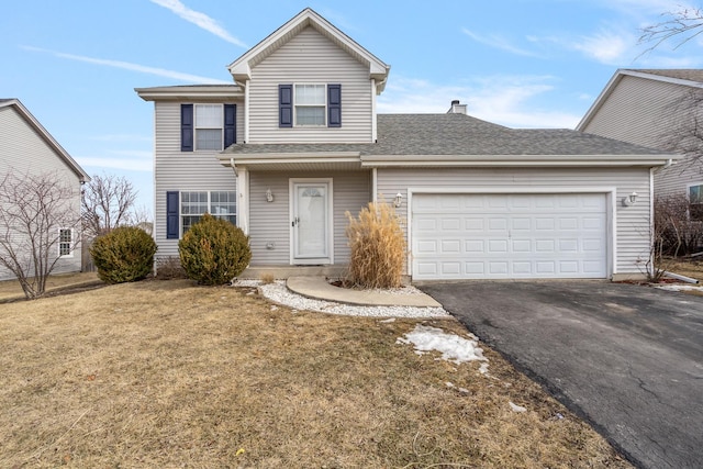 traditional home with a shingled roof, a chimney, aphalt driveway, an attached garage, and a front yard