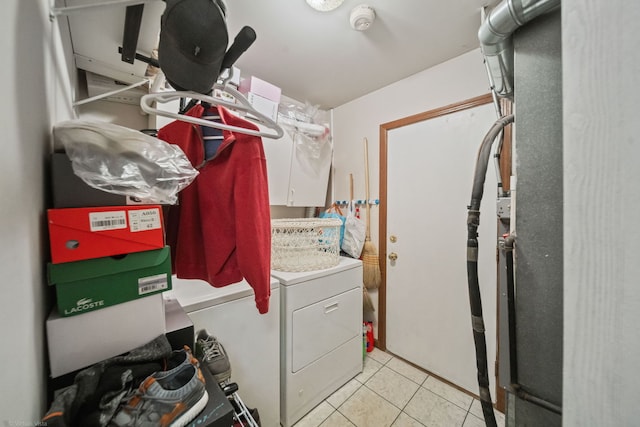 washroom featuring light tile patterned flooring and washer and dryer