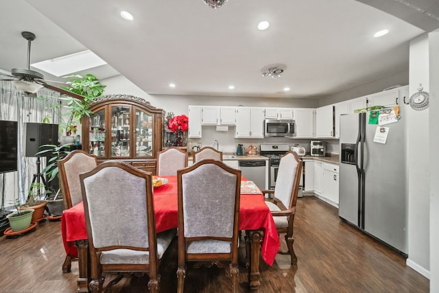 dining room with ceiling fan and dark hardwood / wood-style floors