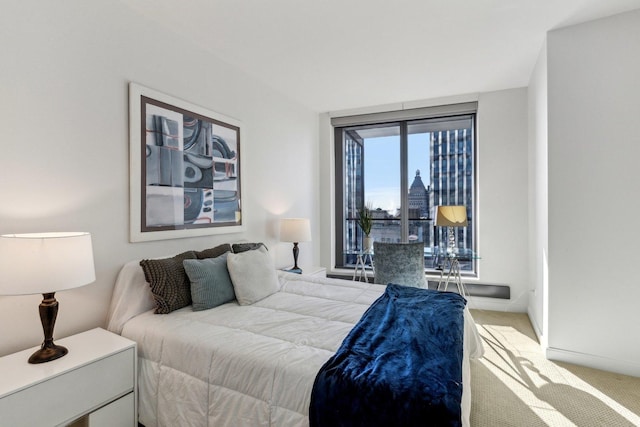 bedroom featuring light colored carpet