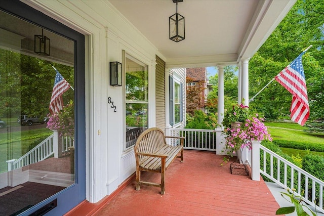 wooden terrace featuring covered porch