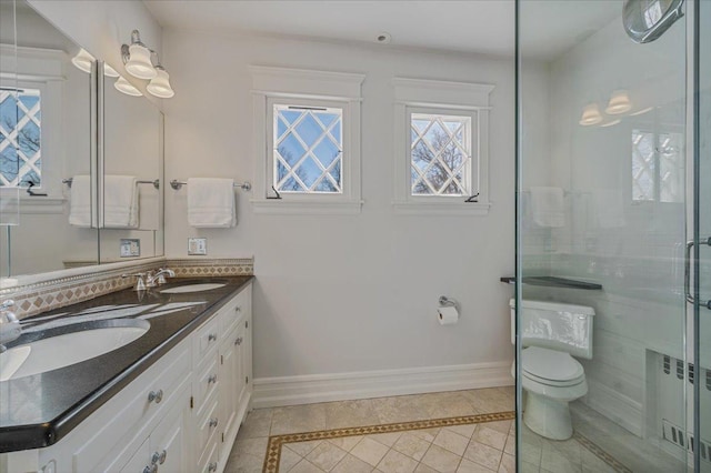 full bathroom featuring toilet, baseboards, a sink, and radiator heating unit