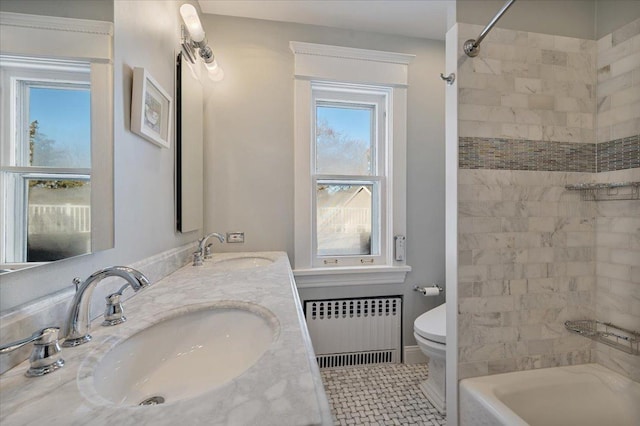 full bath with toilet, a sink, radiator heating unit, and tile patterned floors