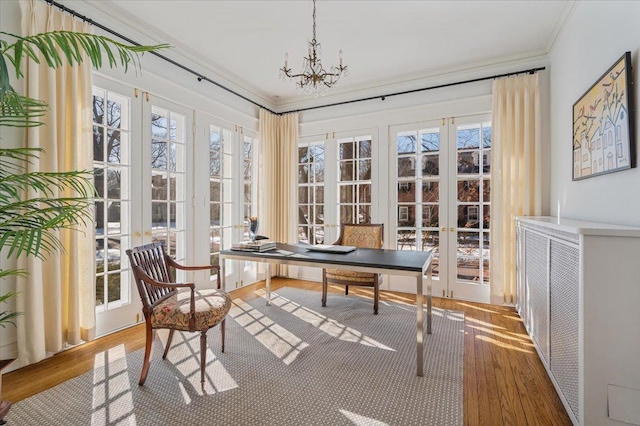 home office with a healthy amount of sunlight, crown molding, and wood finished floors