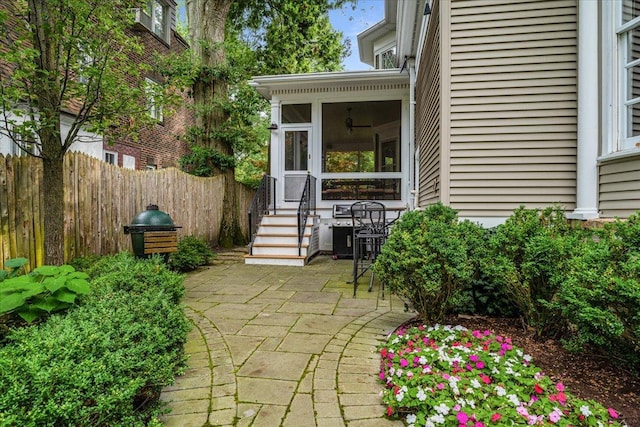 view of patio with a sunroom and fence