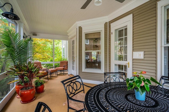 sunroom featuring a ceiling fan