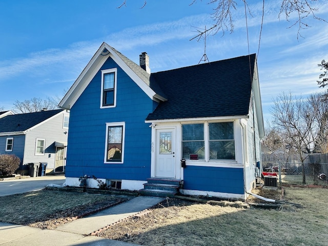 bungalow-style home with central air condition unit