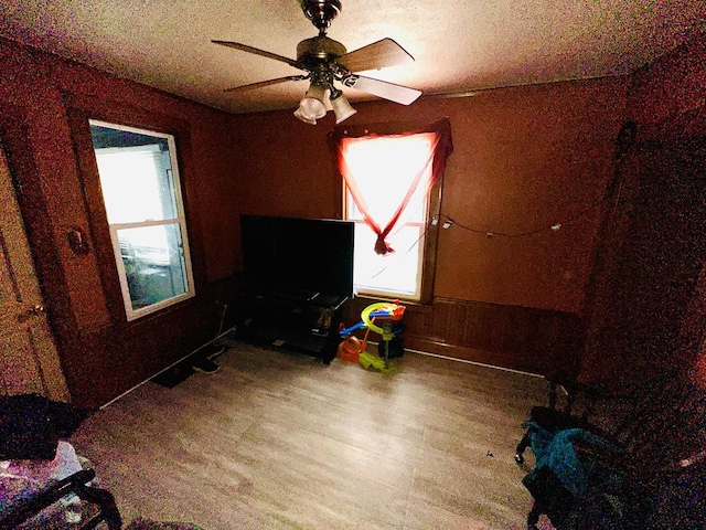 unfurnished bedroom with ceiling fan and hardwood / wood-style floors