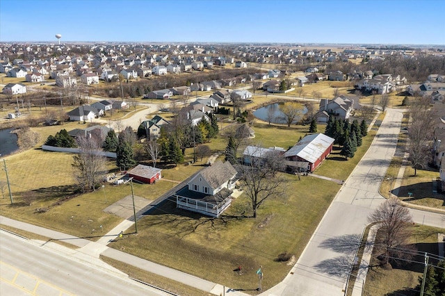 birds eye view of property with a residential view and a water view