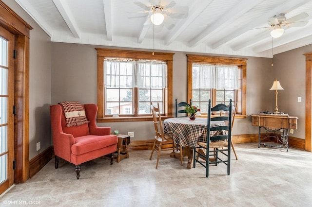 dining room featuring a healthy amount of sunlight, baseboards, and ceiling fan