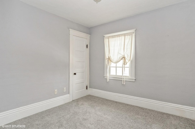unfurnished room featuring baseboards and carpet