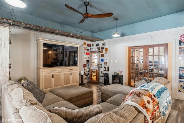 living area with wood finished floors and a ceiling fan