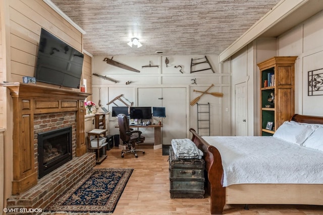 bedroom featuring a fireplace and wood finished floors