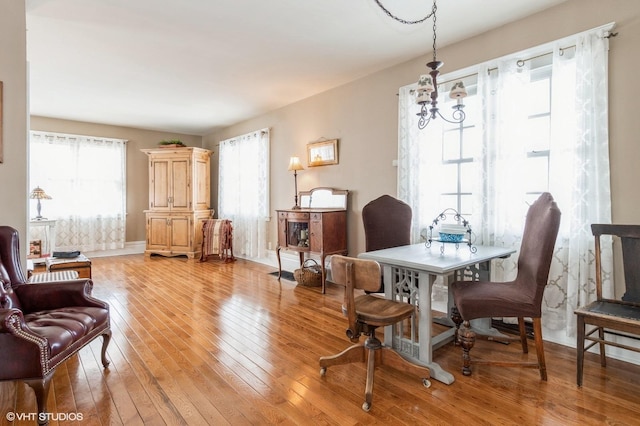 dining room featuring baseboards and light wood-type flooring