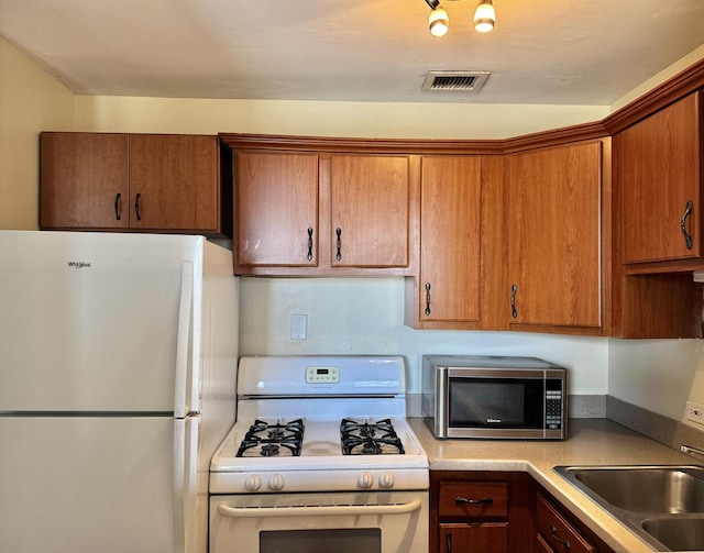 kitchen with sink and white appliances