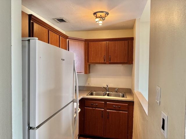 kitchen with sink and white refrigerator