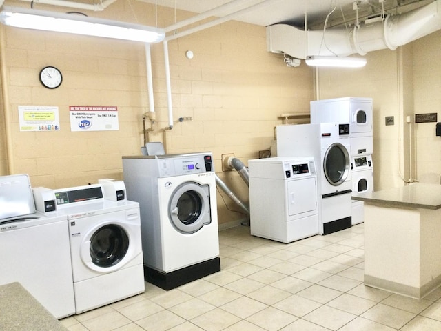 clothes washing area featuring stacked washing maching and dryer, separate washer and dryer, and light tile patterned floors