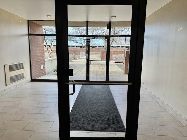 doorway to outside featuring light tile patterned floors