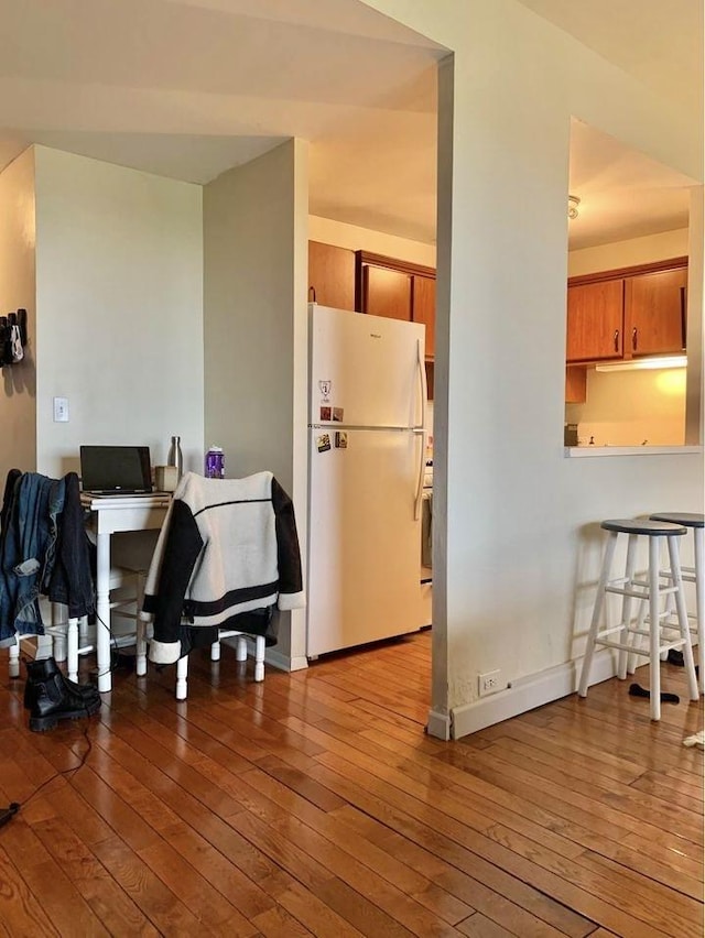 kitchen with light wood-type flooring and white refrigerator