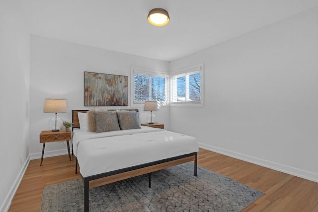 bedroom featuring wood finished floors and baseboards