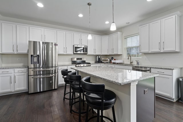 kitchen featuring stainless steel appliances and white cabinetry