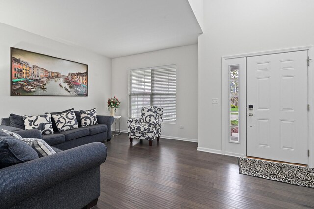 living room featuring baseboards, plenty of natural light, and dark wood-type flooring