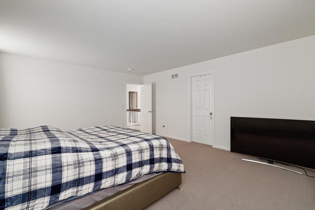 bedroom featuring visible vents, carpet, and baseboards