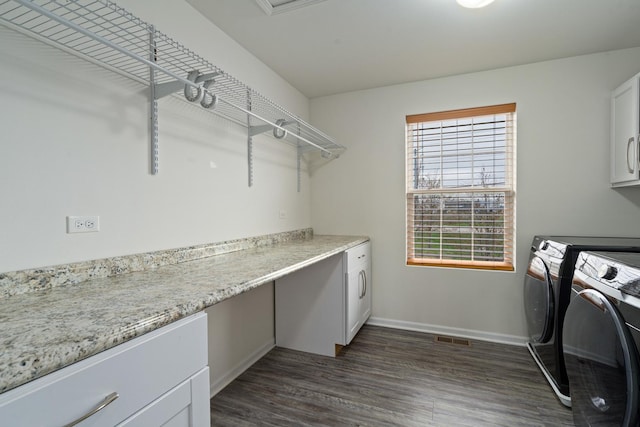 laundry area featuring washer and dryer, dark wood-style flooring, cabinet space, baseboards, and visible vents