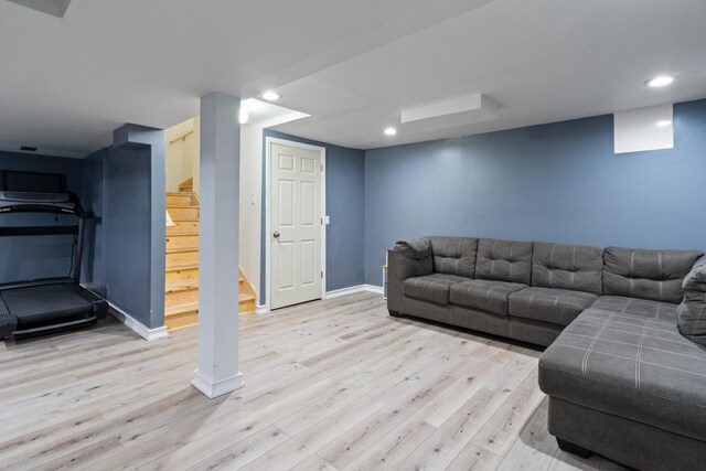 living room featuring recessed lighting, baseboards, stairs, and wood finished floors