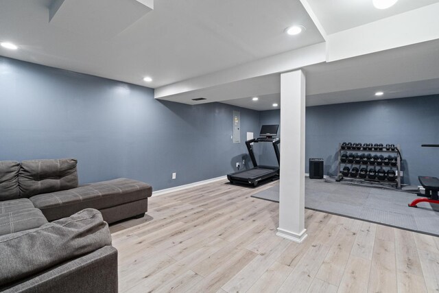 exercise area with baseboards, recessed lighting, and wood finished floors