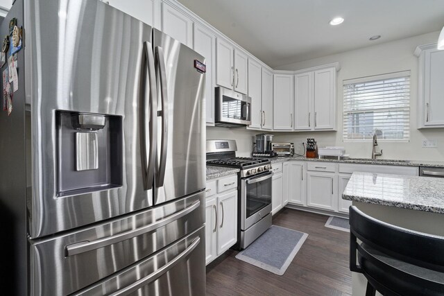 kitchen featuring white cabinets, recessed lighting, appliances with stainless steel finishes, and a sink