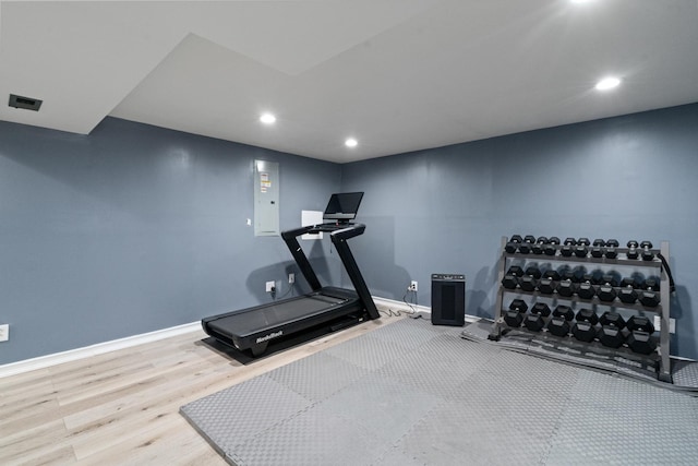 workout area with baseboards, recessed lighting, and wood finished floors