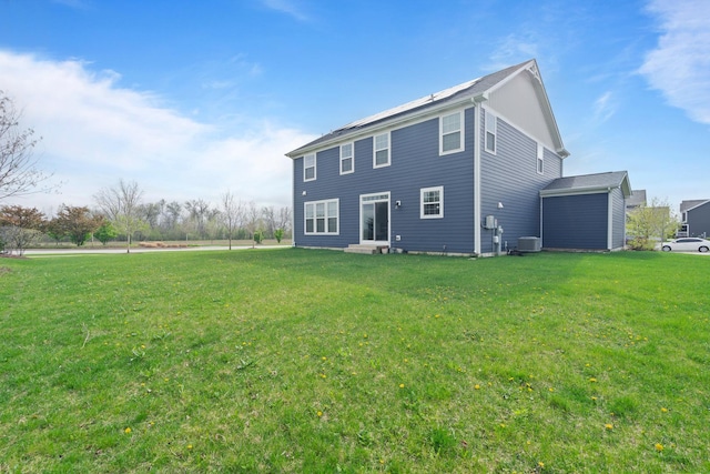 back of property featuring a lawn and central AC